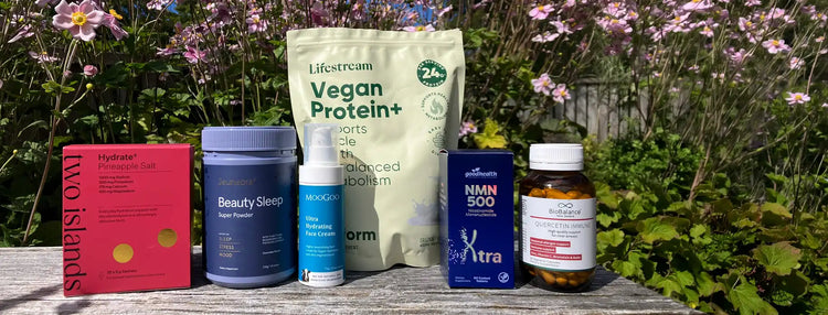 Collection of health and wellness products on a wooden surface with a natural background.