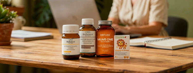 Biobalance, bepure & clinicians Vitamin D products staged on a kitchen counter with a woman on her computer in the background.