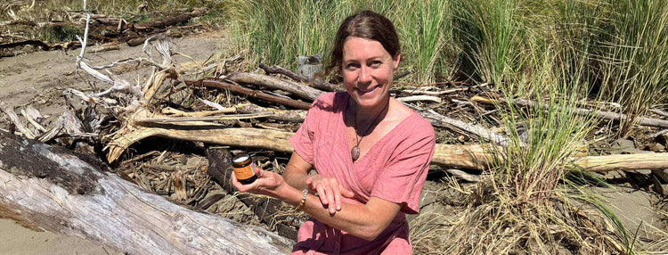 Woman sitting in nature holding a product 