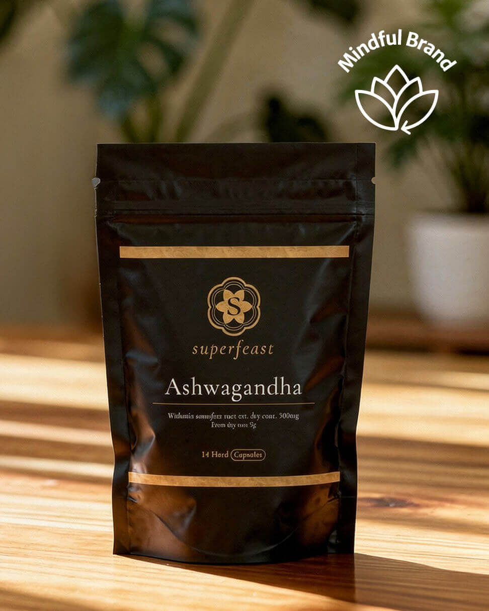 Superfeast Ashwagandha package on a wooden surface with a blurred plant background.