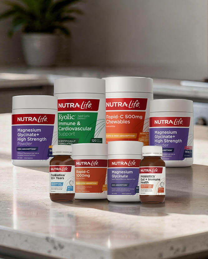 Collection of Nutra Life supplement containers on a kitchen counter.