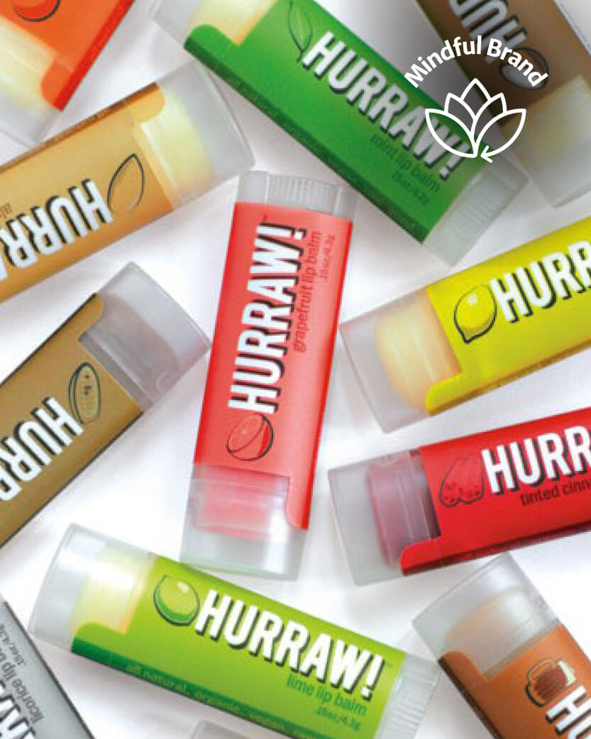 Multiple Hurraw! lip balm tubes in various flavors on a white background