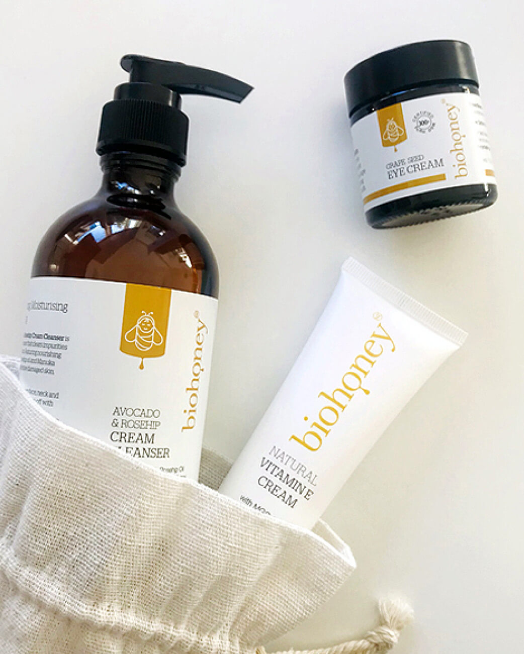 Biohoney skincare products including a bottle, jar, and tube on a white background