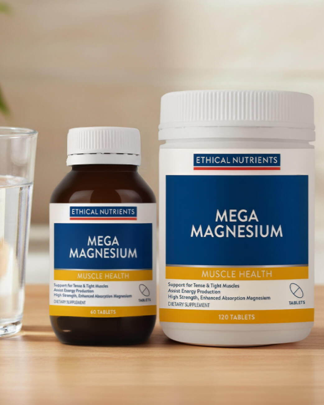 Two bottles of Ethical Nutrients Mega Magnesium on a wooden surface with a glass of water.