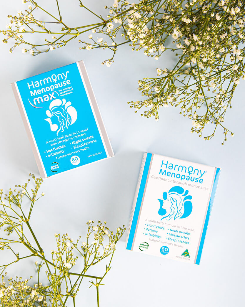 Two boxes of Harmony Menopause products on a light background with flowers.