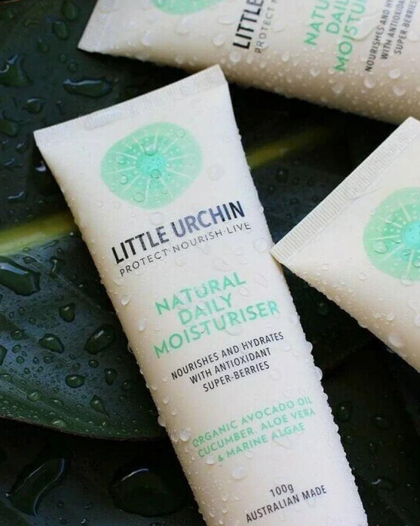 Tube of Little Urchin natural daily moisturiser on a dark background.