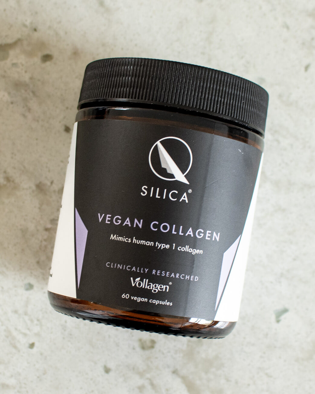 Jar of Silica Vegan Collagen on a textured surface.