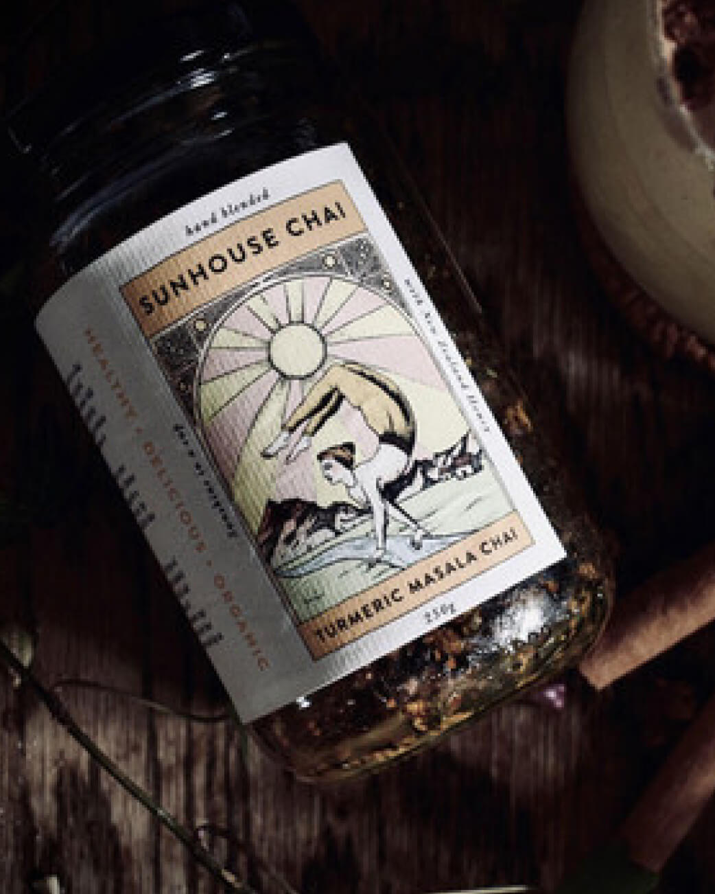 Sunhouse Chai jar with a decorative label on a wooden surface.