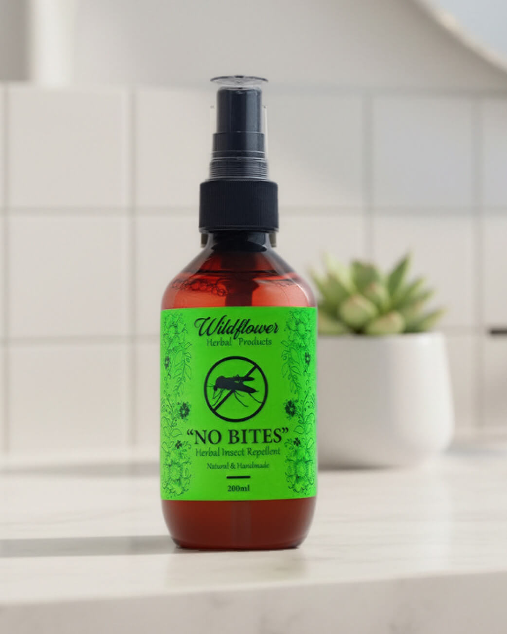 Bottle of 'No Bites' insect repellent spray on a countertop with a blurred background.