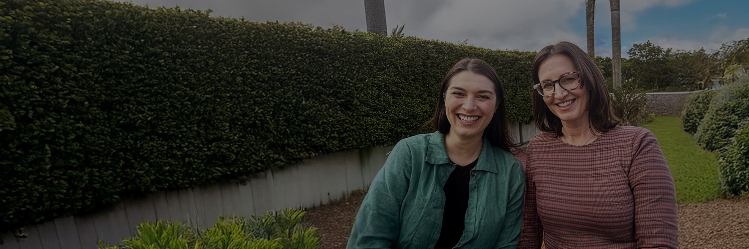 Two women smiling outside.