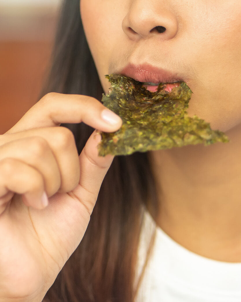 Person eating a seaweed snack