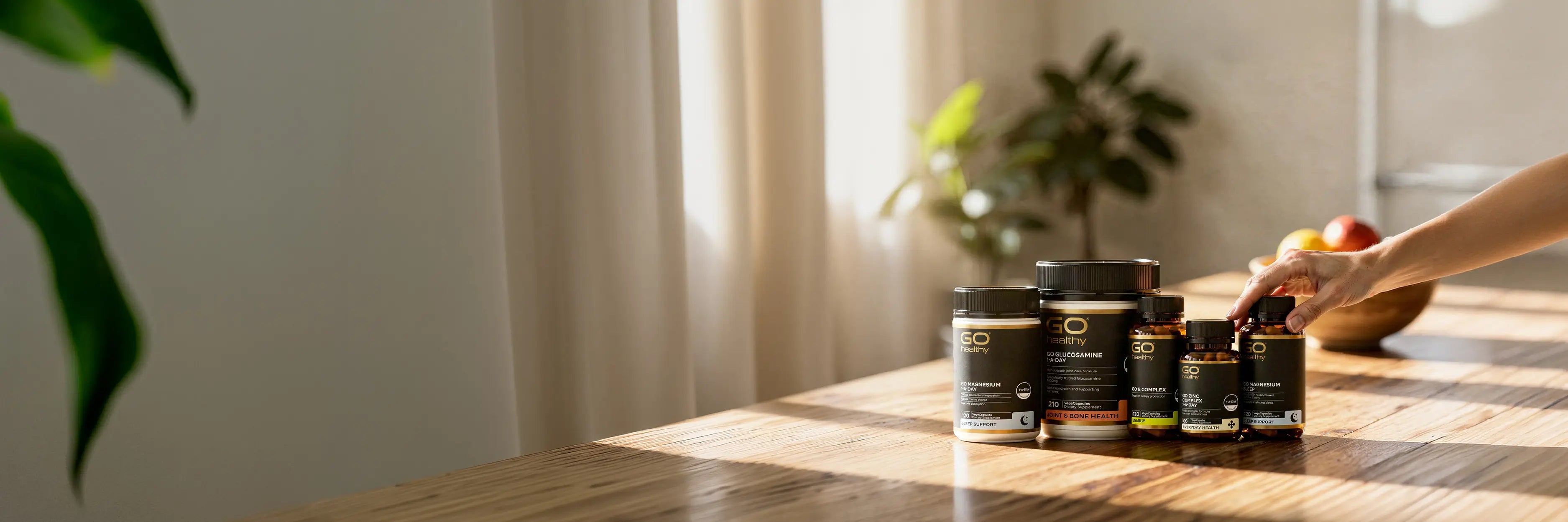 Supplement containers on a wooden table with a blurred background.
