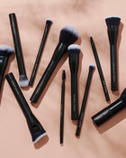 INIKA branded makeup brushes against a pink background.