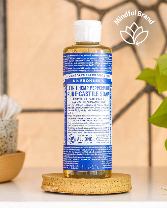 Dr. Bronner's peppermint castile soap on a coaster with a tiled background.