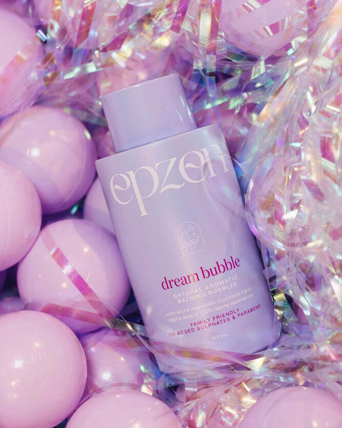 Purple bubble bath bottle in a purple ball pit with tinsel.