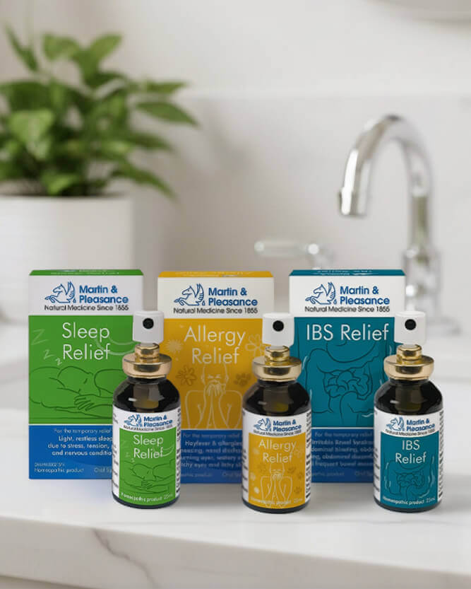 Martin & Pleasance natural medicine bottles and boxes on a bathroom counter with a plant in the background.