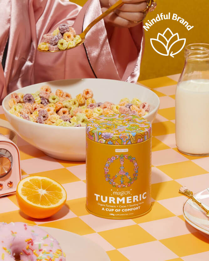 Person eating cereal with a can of 'Turmeric' product on a checkered tablecloth, featuring a mindful brand logo.