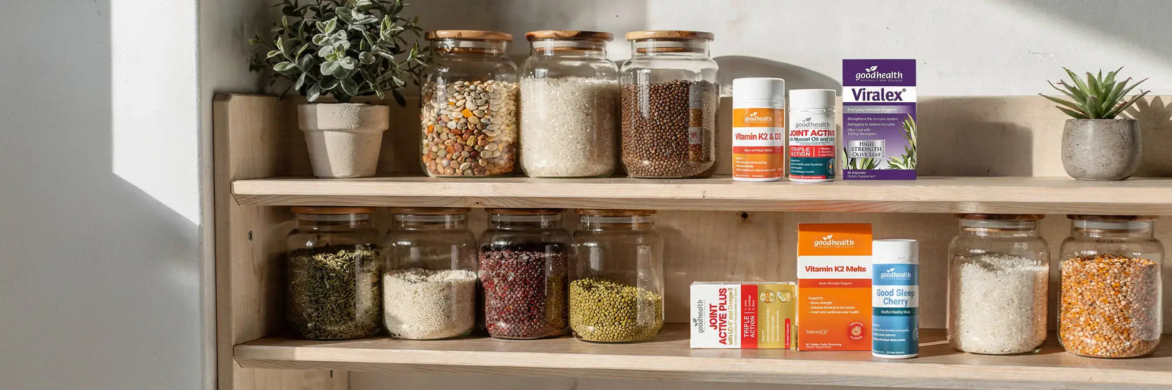 Good Health supplement products on a shelf of jars and plants.
