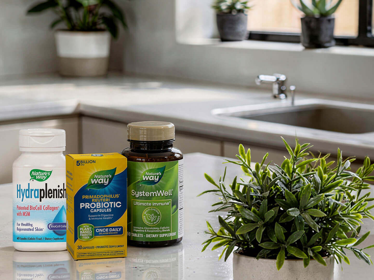 Supplement products on a white kitchen counter next to a plant.