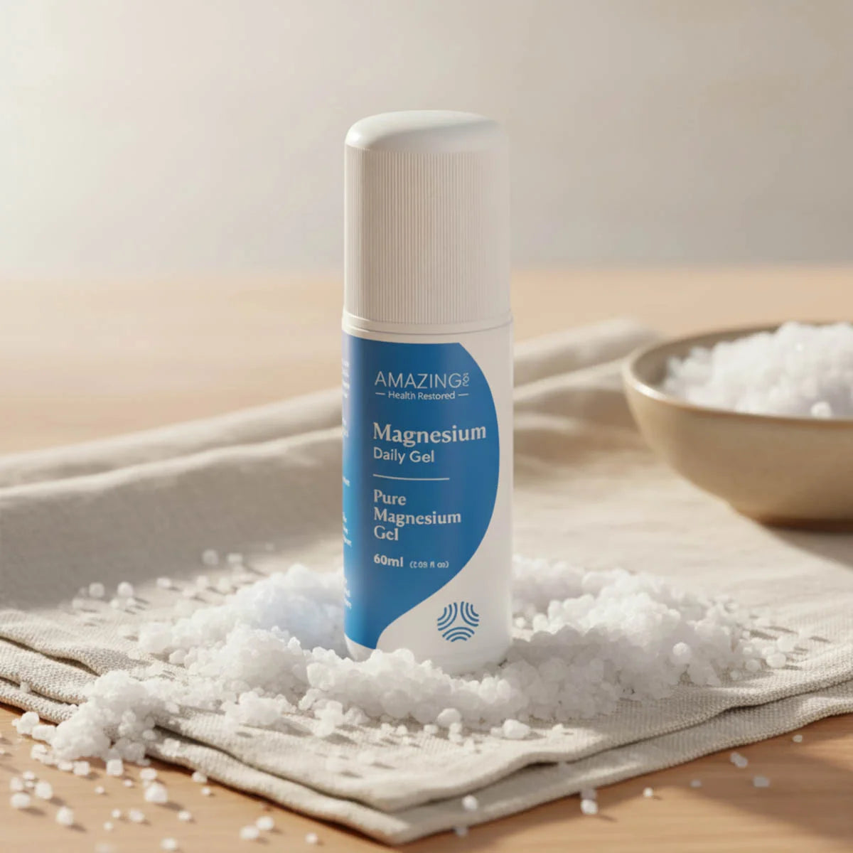 Bottle of magnesium gel on a towel with salt crystals around it.