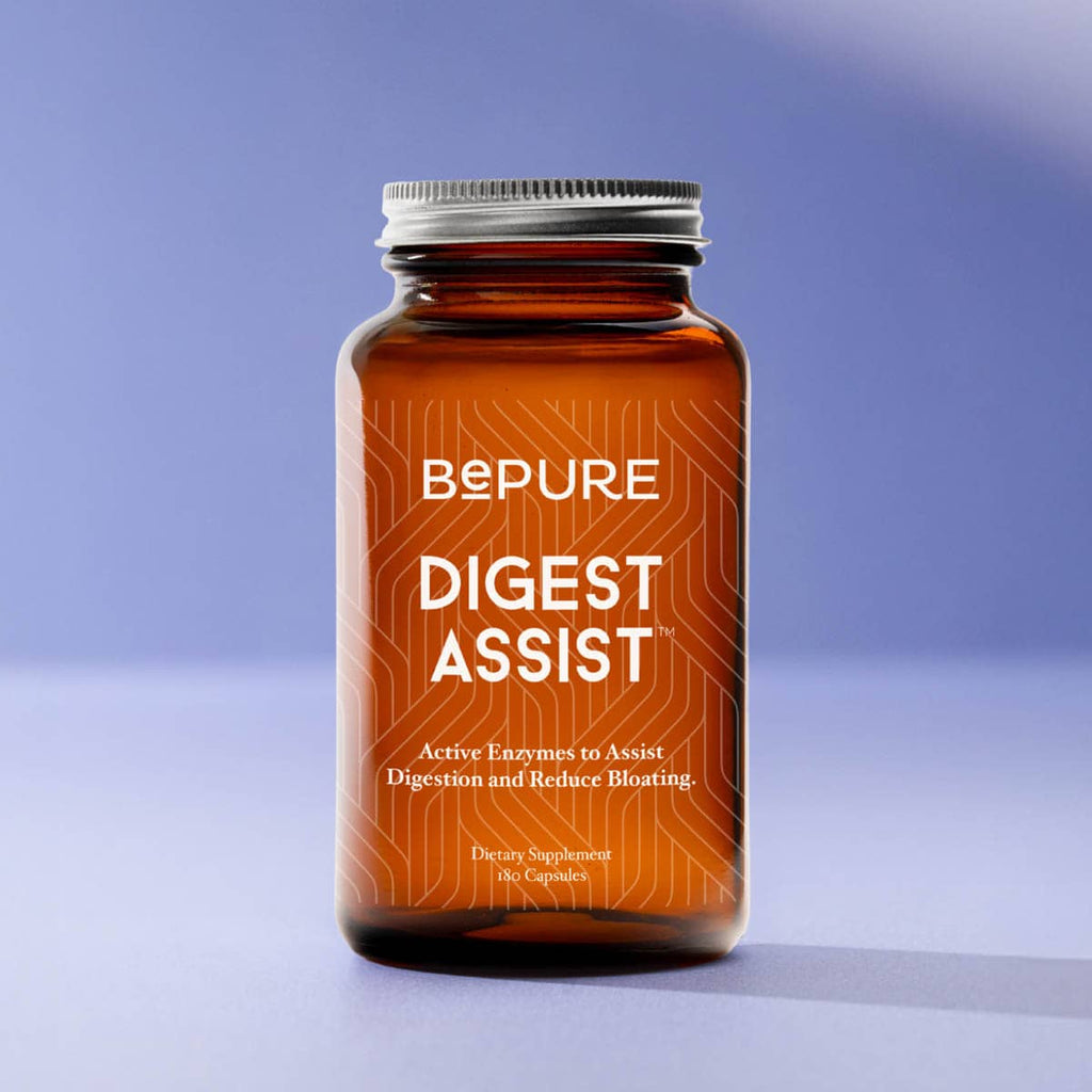 Bottle of BePure Digest Assist 180 capsules supplement on a gradient blue background.