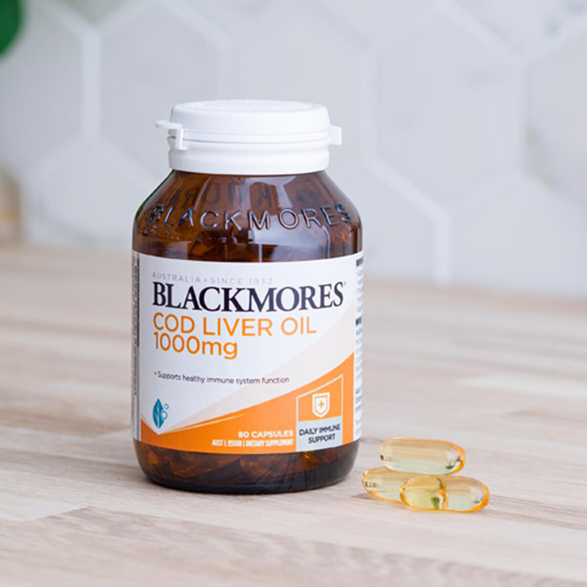 Blackmores Cod Liver Oil 1000mg bottle on a wooden surface.