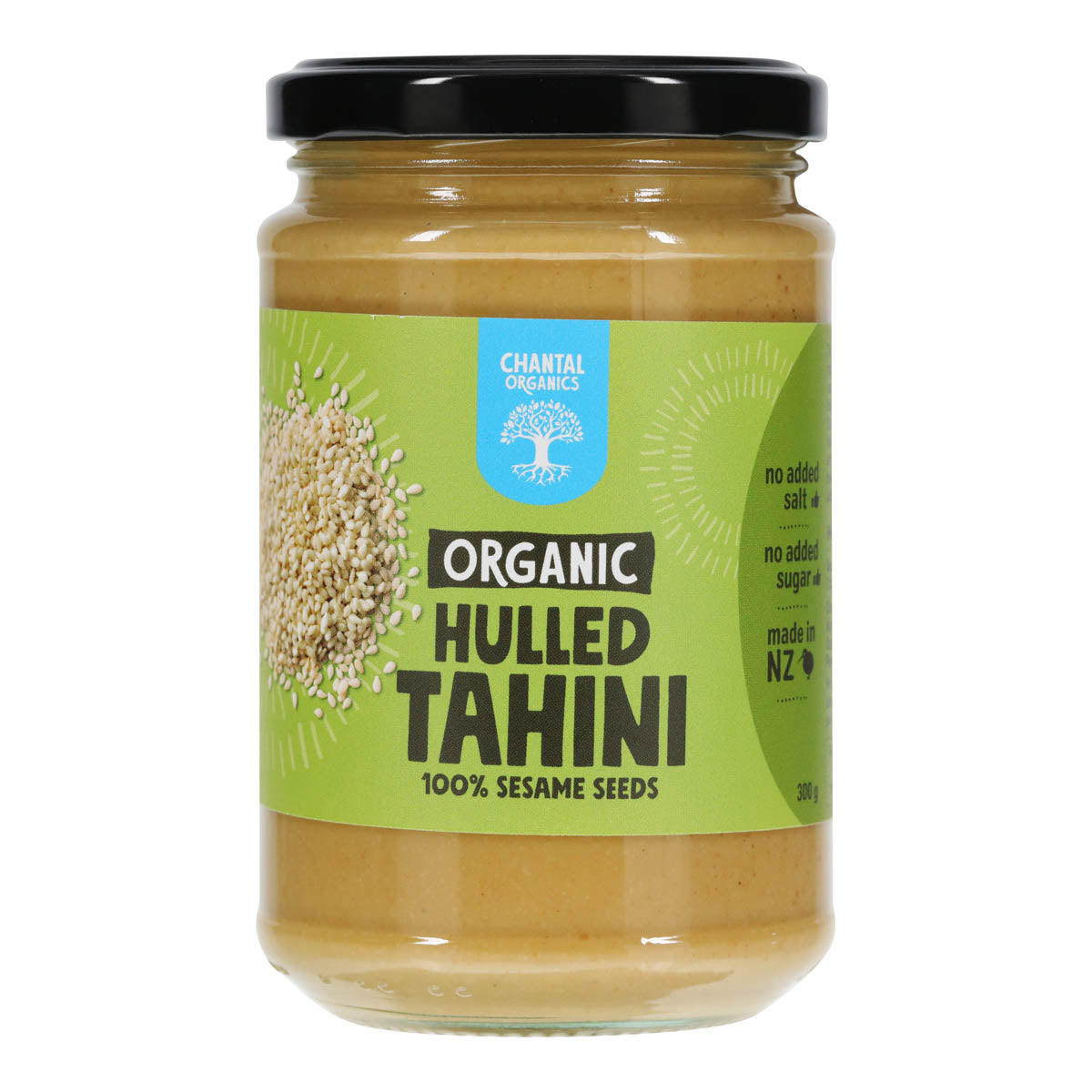 Jar of organic hulled tahini with a green label on a white background