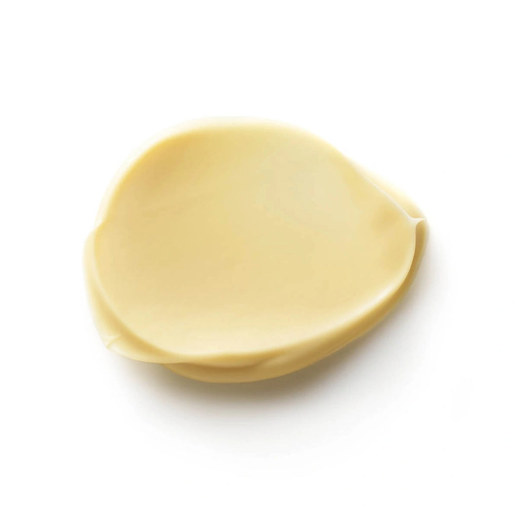 Swatch of dr hauschka apricot day cream - smooth and creamy texture with a slight yellow tint.