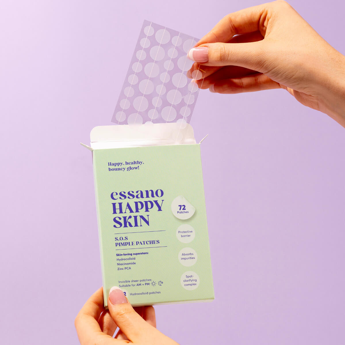 Person holding a green package of essano Happy Skin SOS Pimple Patches against a purple background.