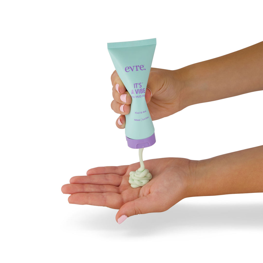 Hand holding a tube of 'evre' cream with a small amount on the palm against a white background.