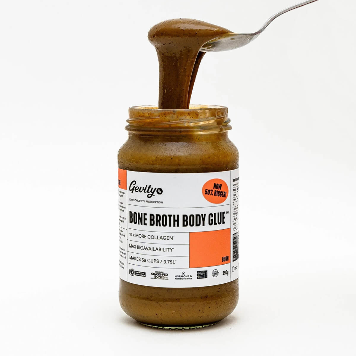 Jar of Gevity Bone Broth Body Glue with a spoonful being poured over it on a white background.
