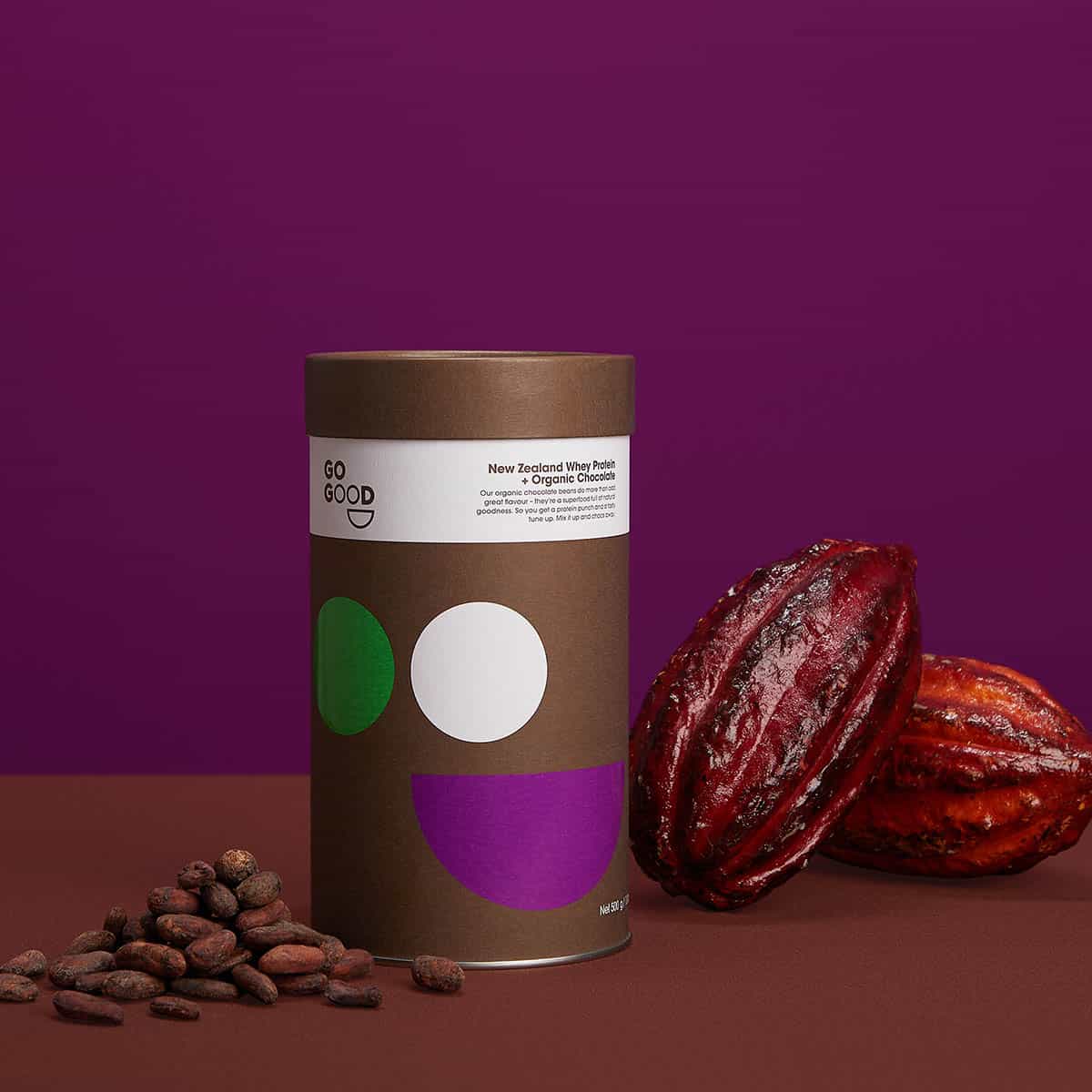 Go Good chocolate product packaging with cacao beans and cacao nibs on a purple background.