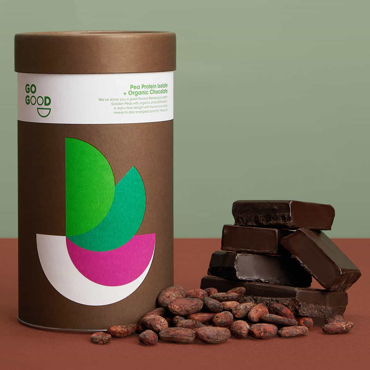 Go Good protein bars with a brown container on a red surface.