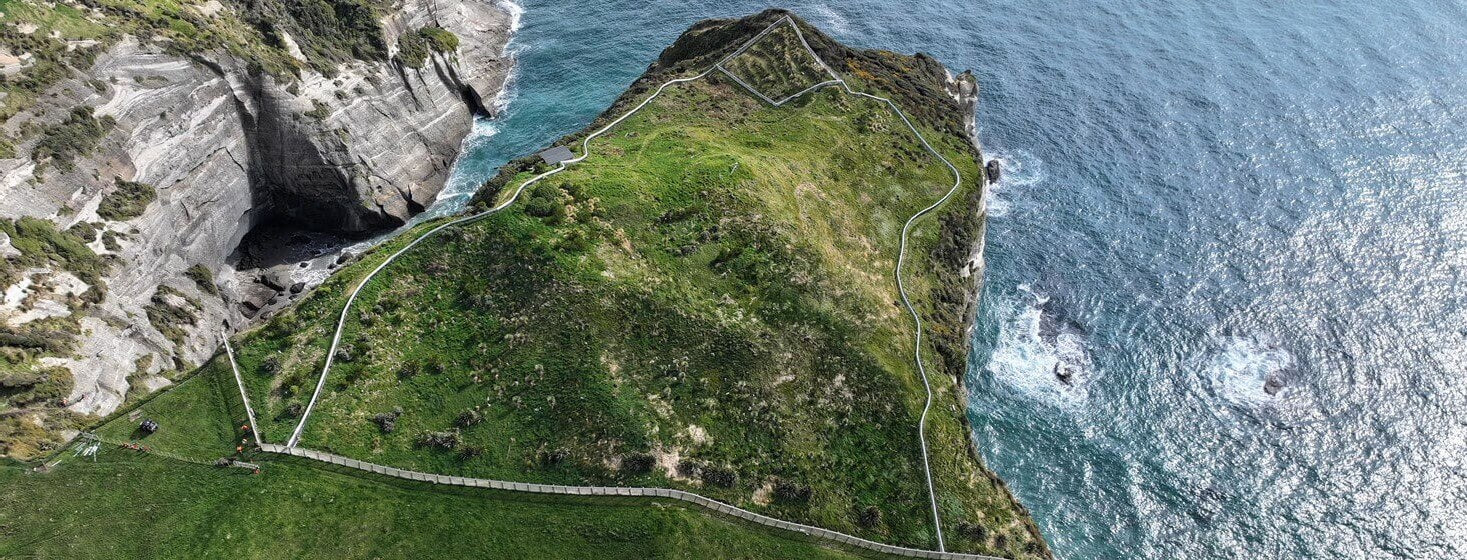 Birdseye view of HealthPost Nature Trust next to the ocean.