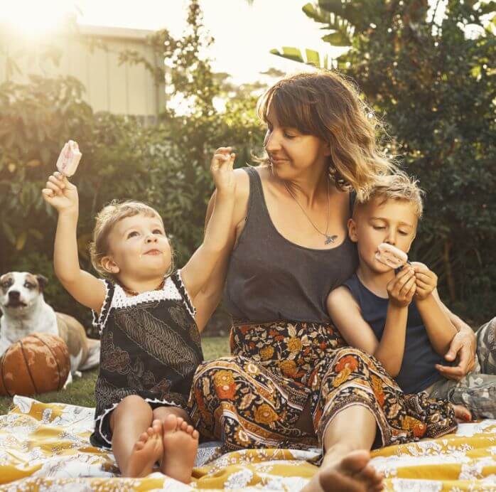 mum, kids and dog having a picnic