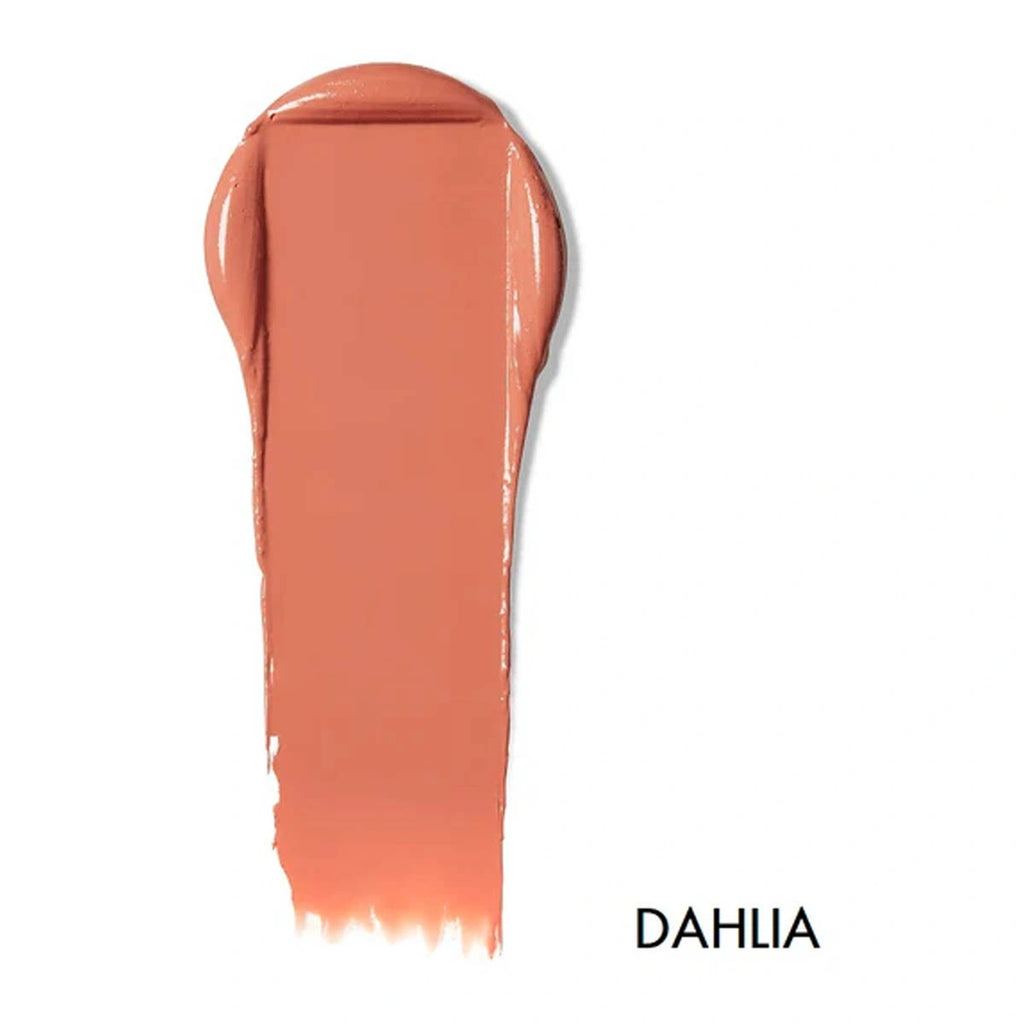 Swatch of lip & cheek cream in the shade 'Dahlia'. Warm pink-coral toned nude.