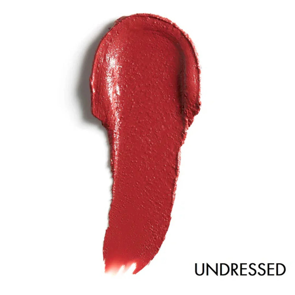 Red lipstick swatch on a white background with 'UNDRESSED' text