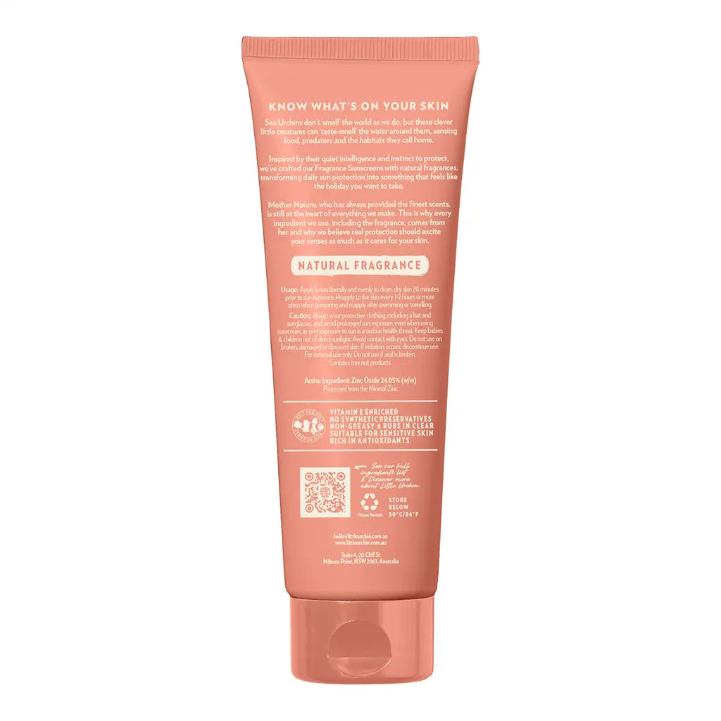 The back of a coral pink squeeze tube for sunscreen, showing detailed ingredient and usage text, on a solid white background.