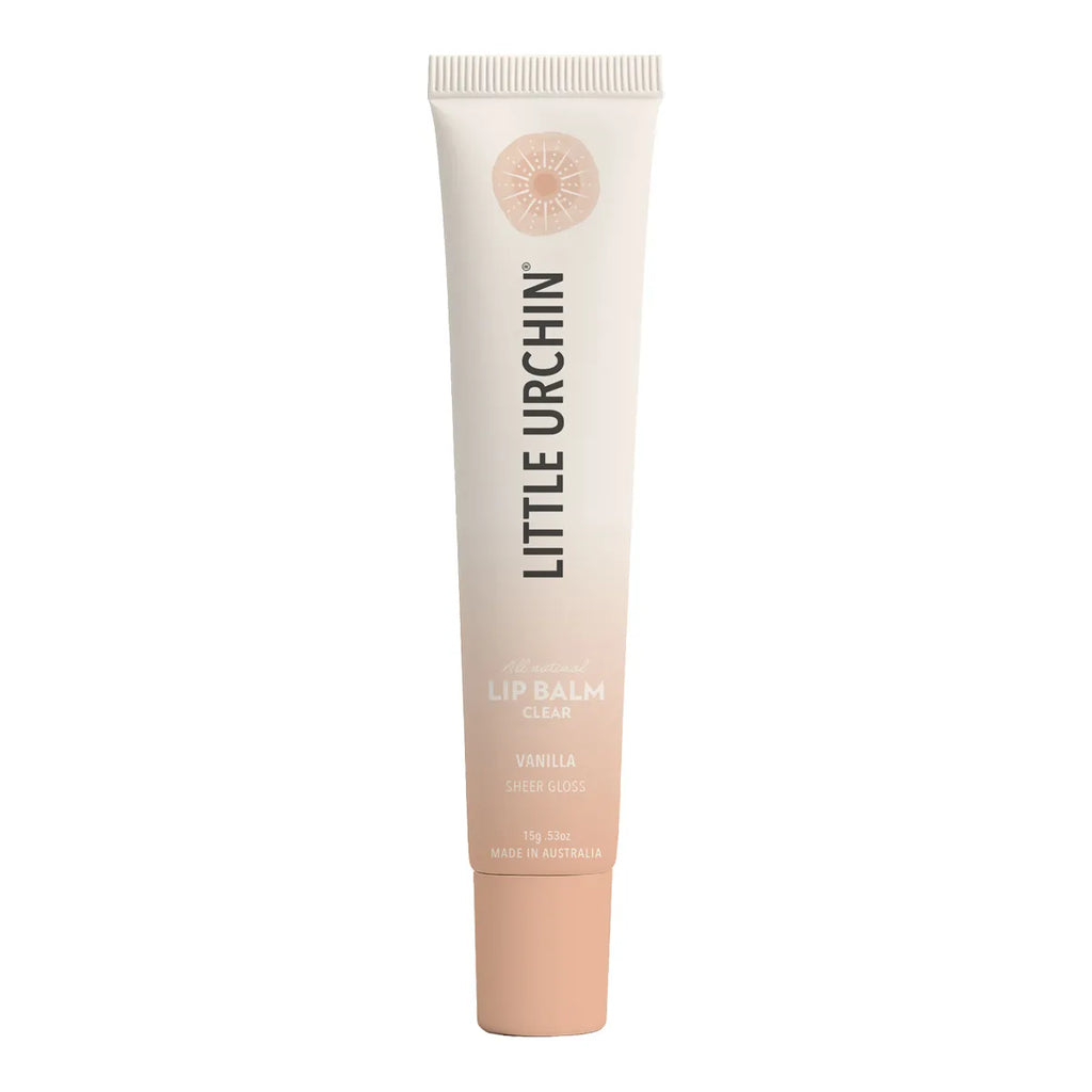 A tube of Little Urchin Clear lip balm in Vanilla, featuring a soft cream-to-rose-pink gradient with a peach-colored cap, shown on a solid white background.