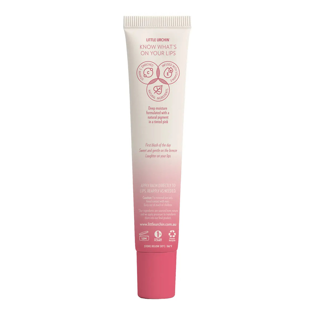 Back of tube of strawberry lip balm, featuring a pink gradient at the bottom, with pink text and icons.