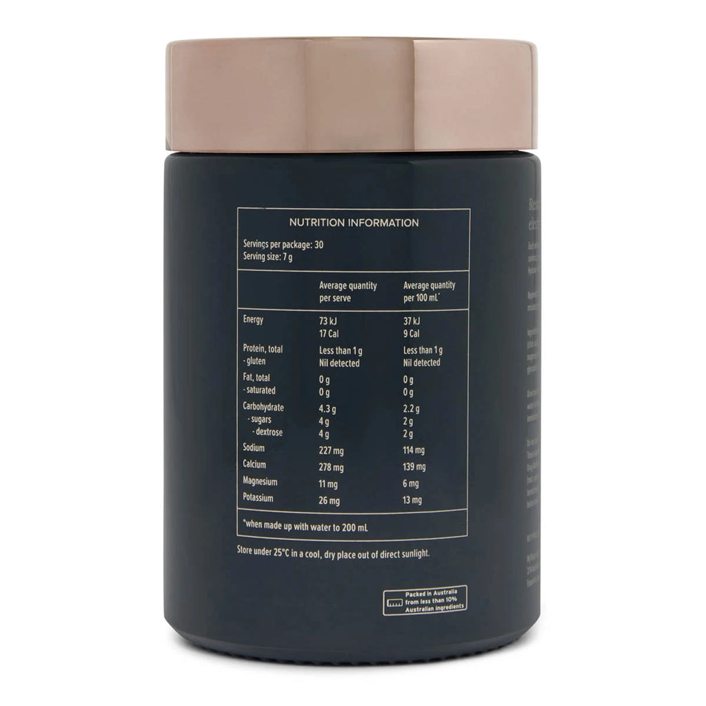 A black supplement bottle of electolyte powder with a rose gold lid, showing the back of the package with printed nutrition information on a white background.