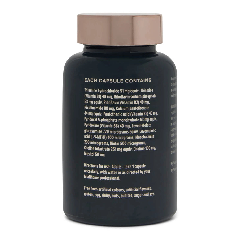 A black supplement bottle with a metallic rose gold cap, showing the back side with white text detailing the ingredients and directions, on a white background.