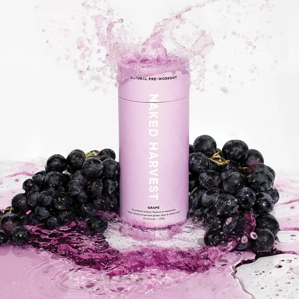 Pink supplement bottle labeled 'Naked Harvest' with grapes and a splash effect on a white background.