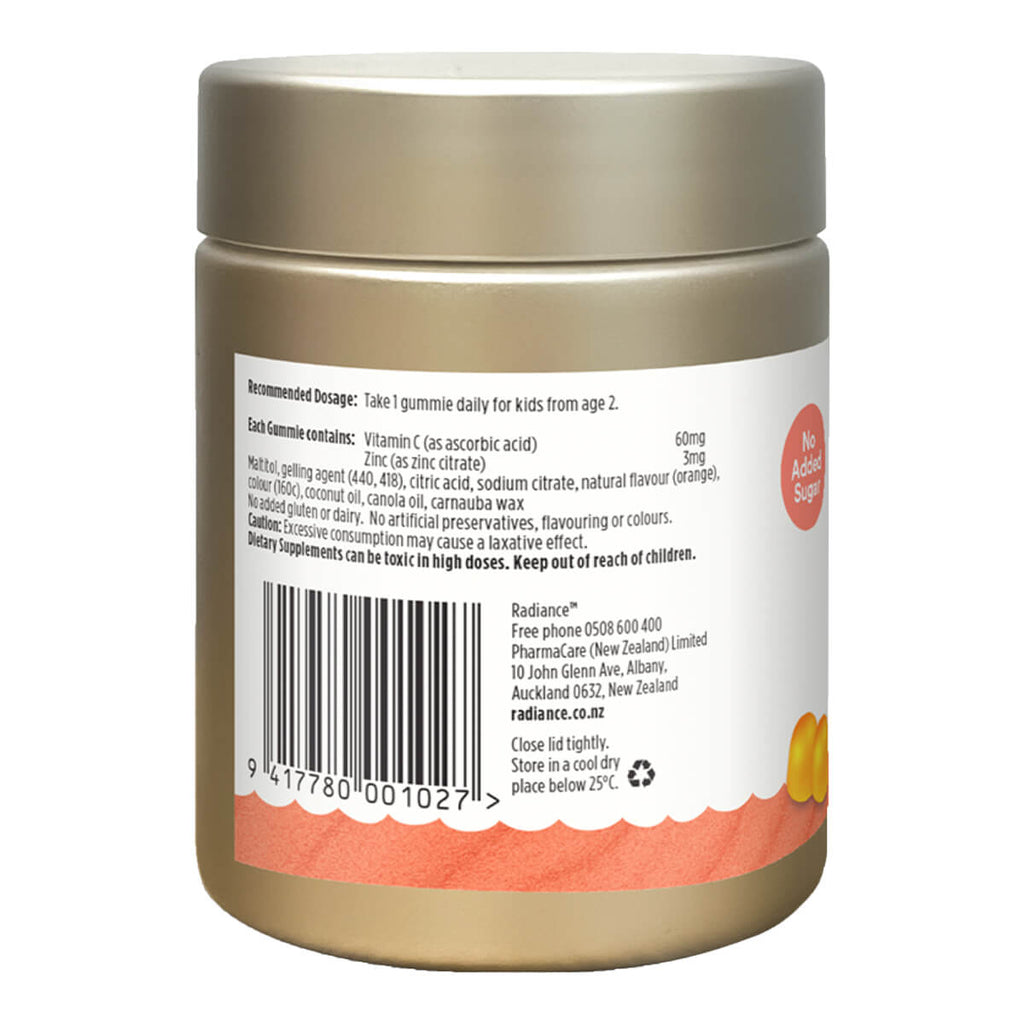 Back view of a gold container with a label on a white background