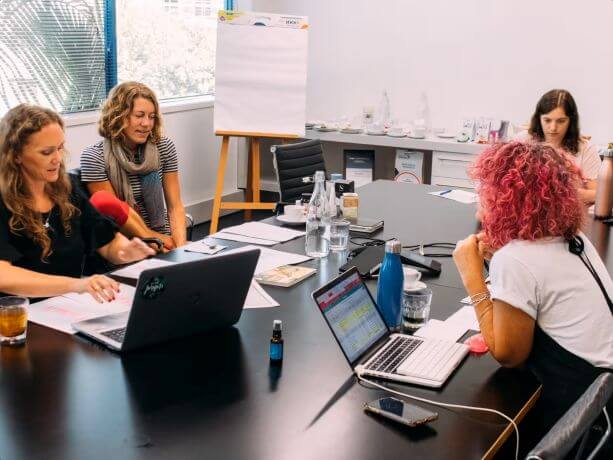 Lucy and team reviewing products in an office setting.