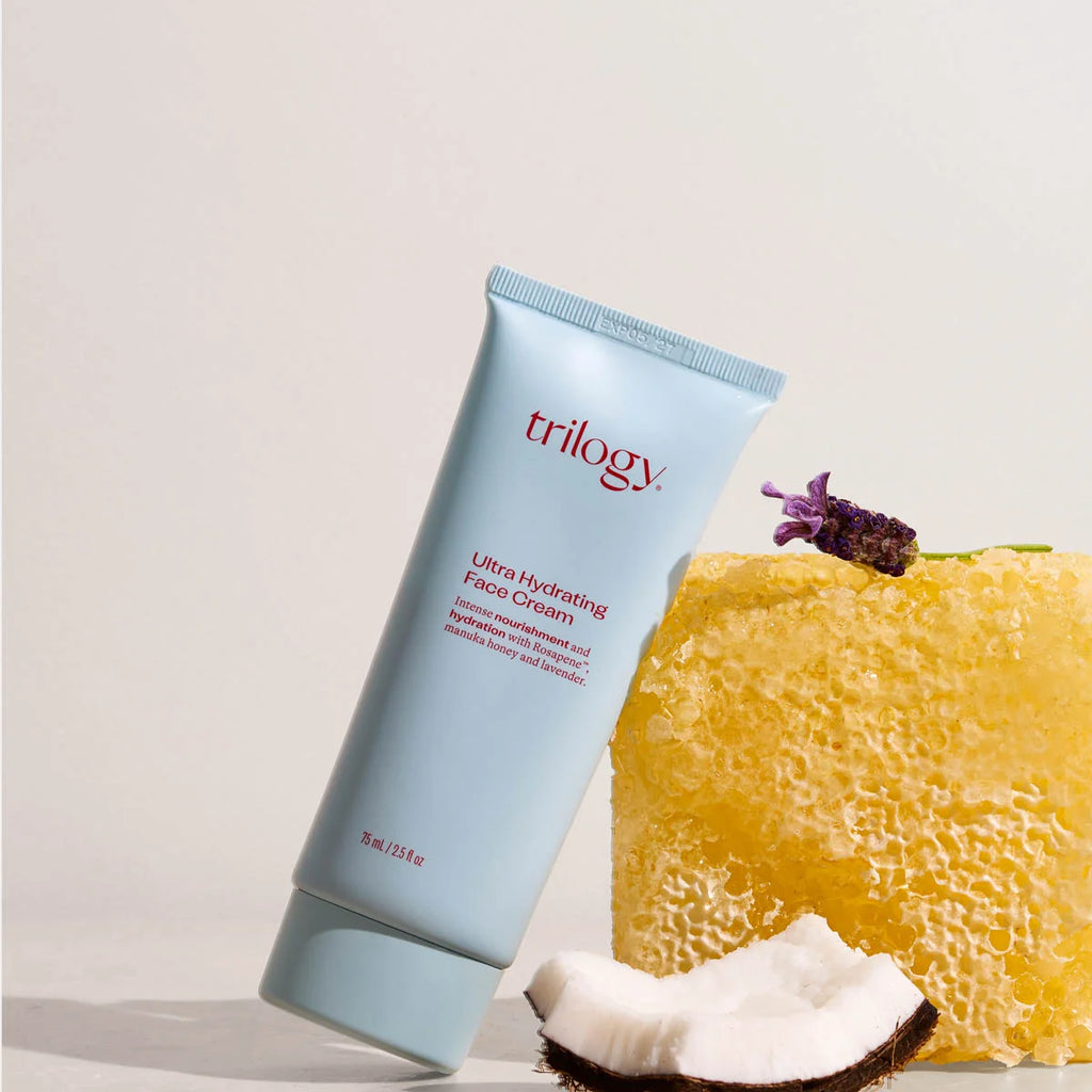 Trilogy ultra hydrating face cream with a honeycomb and coconut on a light background