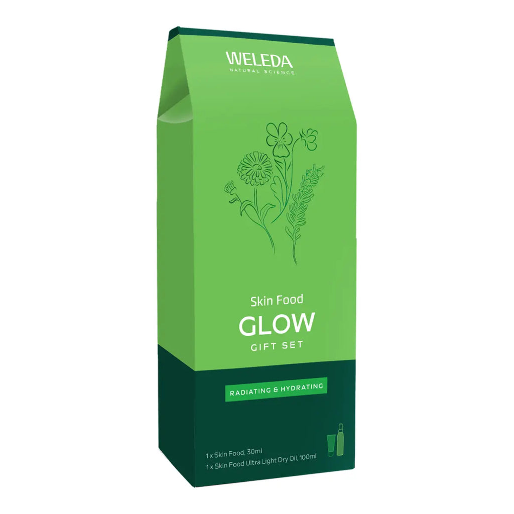 A green and dark green Weleda Skin Food Glow Gift Set box, featuring botanical line drawings and white text, on a plain white background.