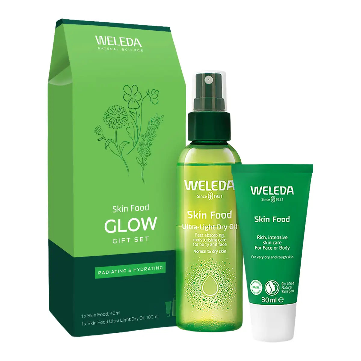 Weleda Skin Food Glow Gift Set featuring a green paperboard box, a spray bottle of ultra-light dry oil, and a tube of Skin Food cream, all on a white background.