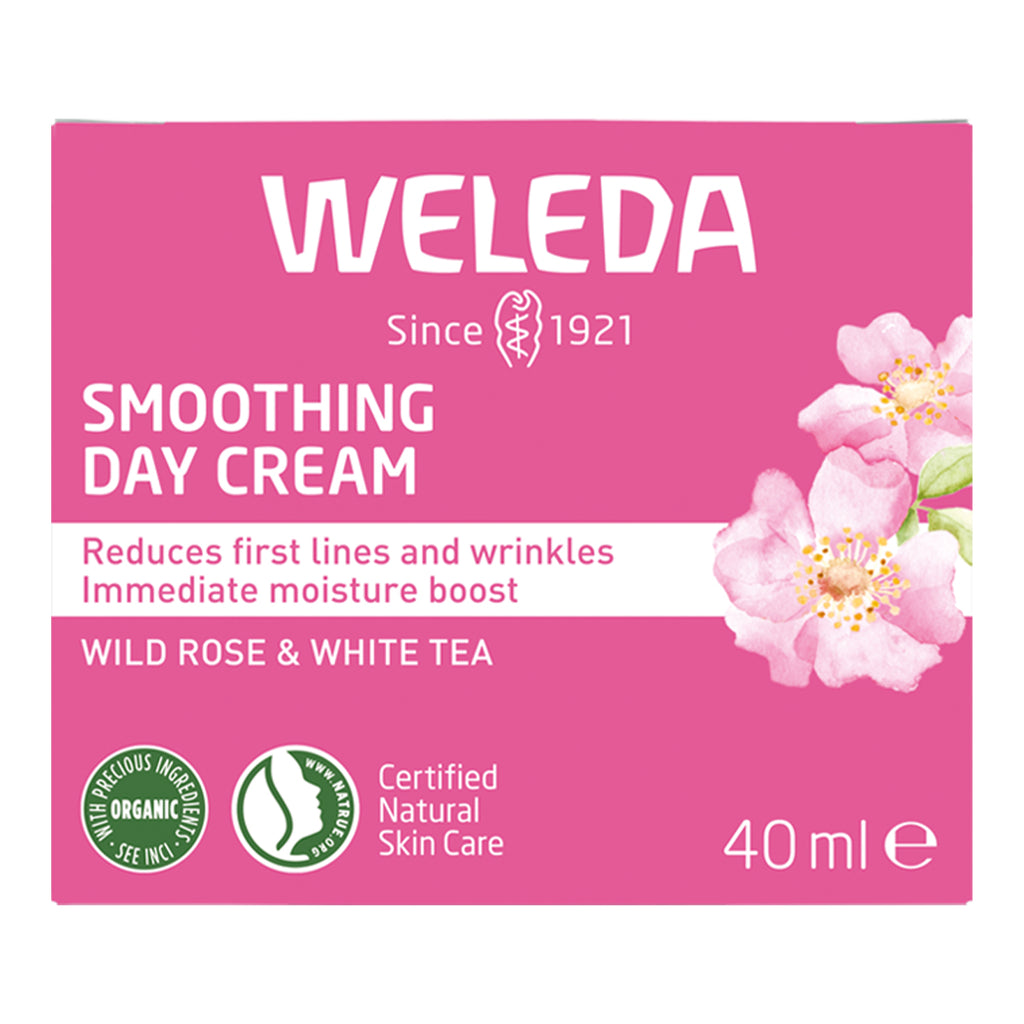 Weleda smoothing day cream packaging with pink background and floral design.