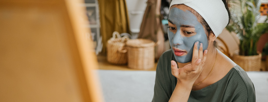 woman applying a beauty mask to her face